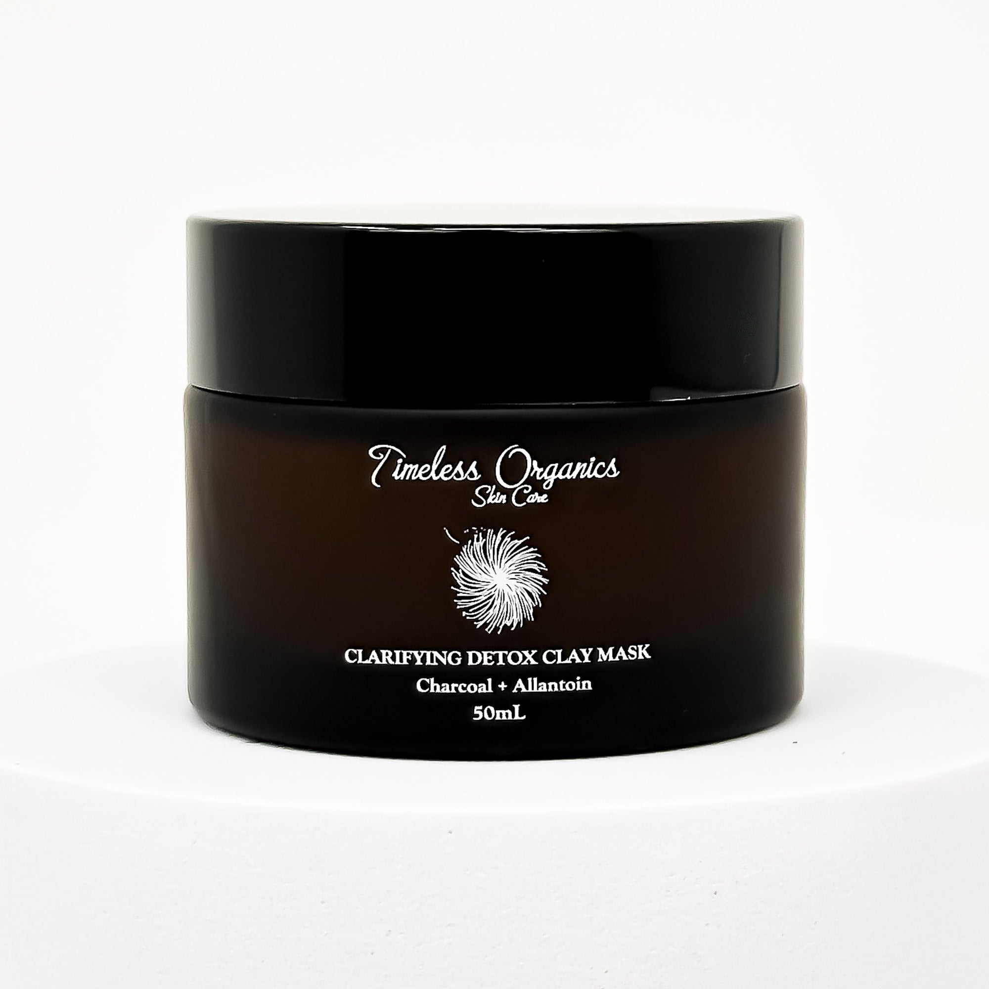 Black jar of Timeless Organics Clarifying Detox Clay Mask on a white background