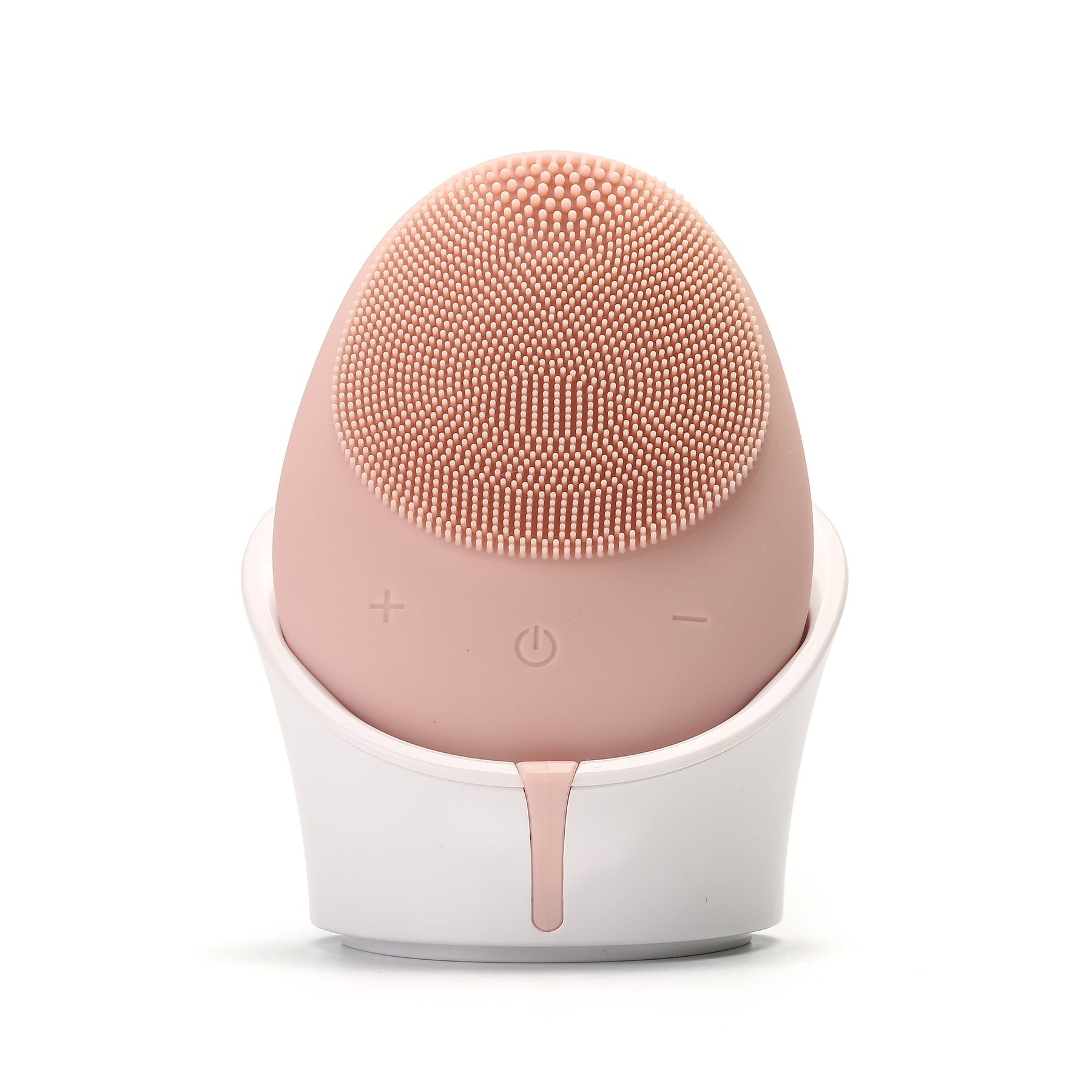 Pink facial cleansing brush with white base on a white background